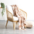 alt="A meticulously crafted shade of tan and white blanket with captivating large checks design, made of high-quality cotton knit for durability and comfort."