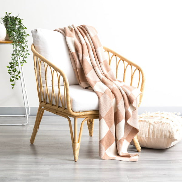 alt="A meticulously crafted shade of tan and white blanket with captivating large checks design, made of high-quality cotton knit for durability and comfort."