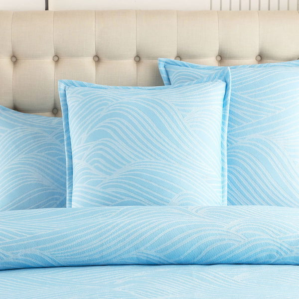 alt="A shades of blue european pillowcase with a beach wave design"