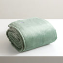 A sumptuous, generously-sized, eucalyptu ultra-soft velvet blanket, elegantly folded on a pristine white surface.