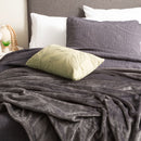 Lavish bed adorned with a pristine graphite ultra soft velvet blanket and generously oversized.