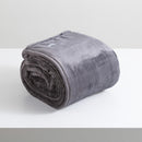 A sumptuous, generously-sized, graphite ultra-soft velvet blanket, elegantly folded on a pristine white surface.
