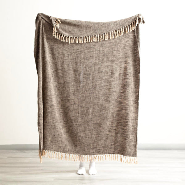 Renee Taylor Chevron Throw draped over a rattan chair for a natural, relaxed look