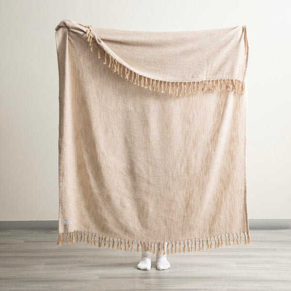 Full-size Renee Taylor Natural Chevron Throw being held up to show size and drape