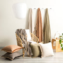 Renee Taylor Surrey Chevron Olive Throw styled in a cosy living room scene with cushions