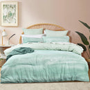 Renee Taylor Terrain green quilt cover set styled on bed with soft botanical tones
