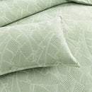Close-up of textured banana leaf jacquard design in soft sage green

