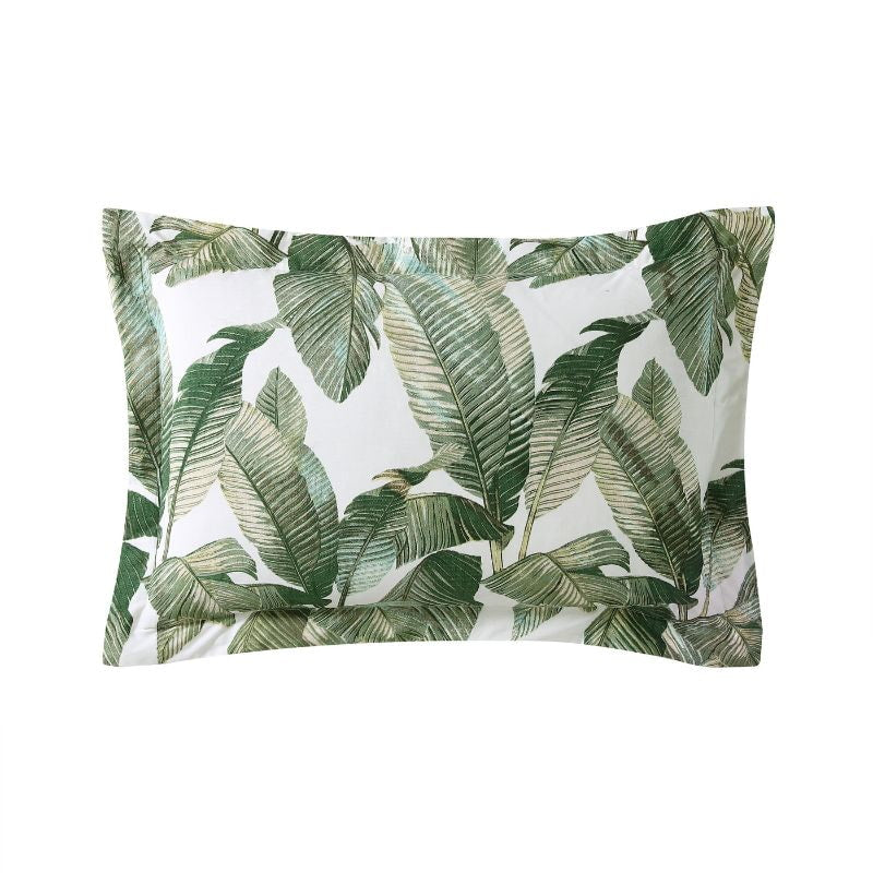 A luxurious tropical print pillowcases with palm leaves, perfect for a peaceful and comfortable siesta. 
