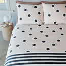 alt="Dotted and striped quilt cover with hand-painted black and white dots on a cream background on the top side and horizontal black and white stripes on the underside"