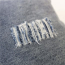 alt="Closer look of a denim distressed european cushion"