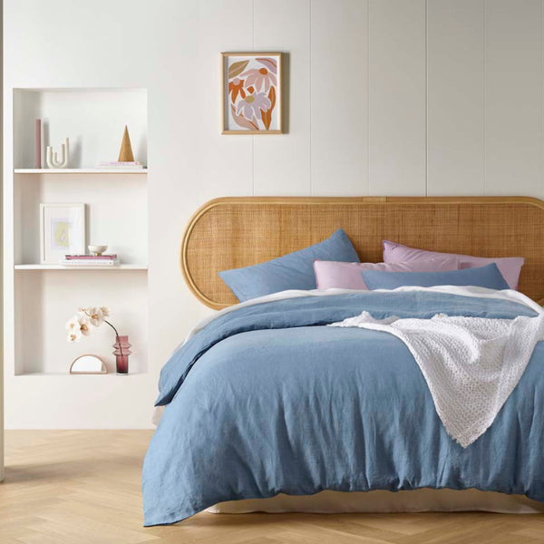 alt="An elegant French linen denim blue quilt cover adding freshness to a bedroom"