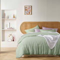 alt="An elegant French linen pistachio quilt cover adding freshness to a bedroom"