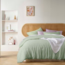 alt="An elegant French linen pistachio quilt cover adding freshness to a bedroom"