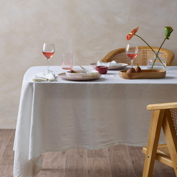 alt="Featuring white french linen tablecloth in a luxurious table setup"