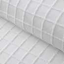 Closer look of a white quilt cover and pillowcases in a stylish and modern design add a touch of elegance to your bedroom.