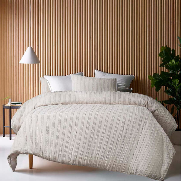 alt="A natural quilt cover set featuring chenille stripes and minimalistic style on a cosy bedroom"