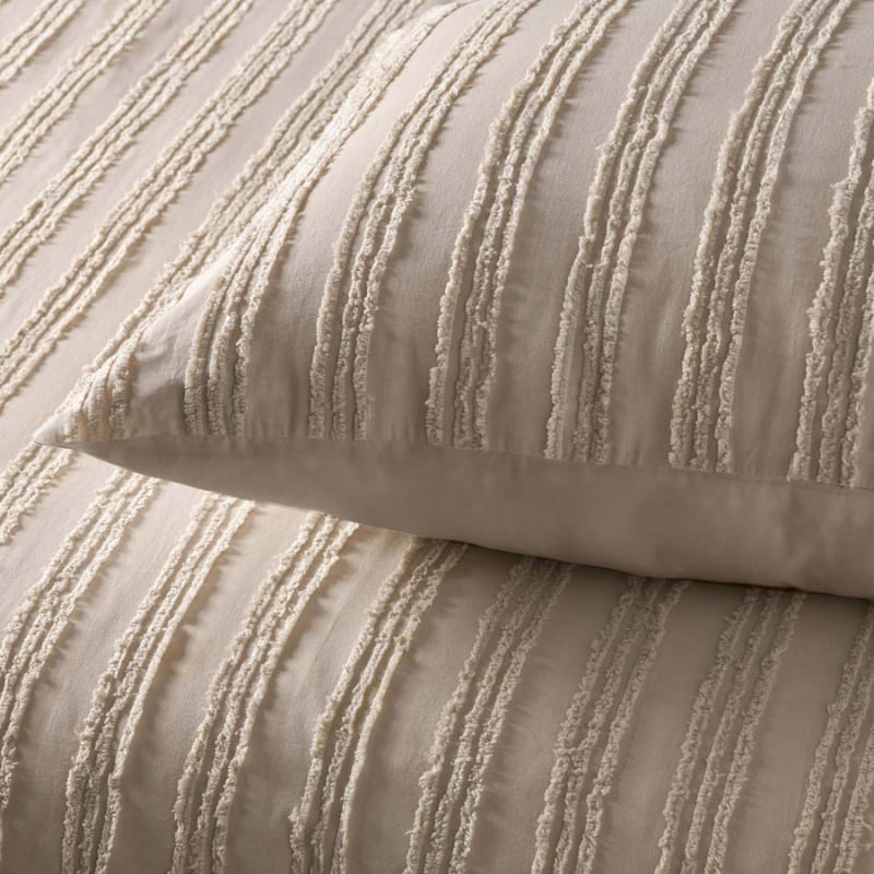 alt="Close up details of a natural quilt cover set featuring chenille stripes and minimalistic style"