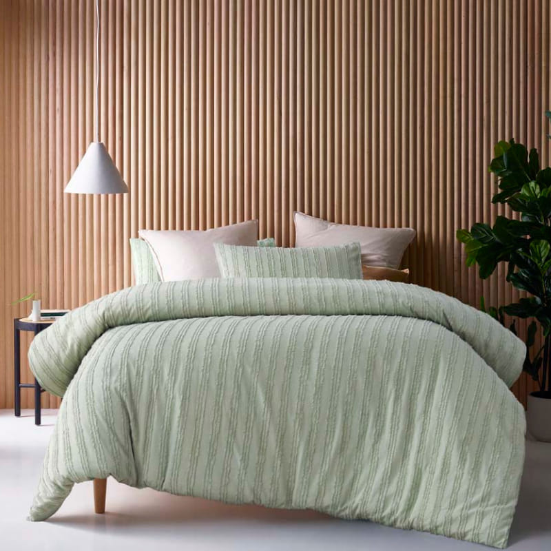 alt="A sage quilt cover set featuring chenille stripes and minimalistic style on a cosy bedroom"