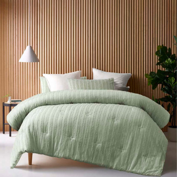 alt="A sage comforter set featuring chenille stripes design on a cosy bedroom"