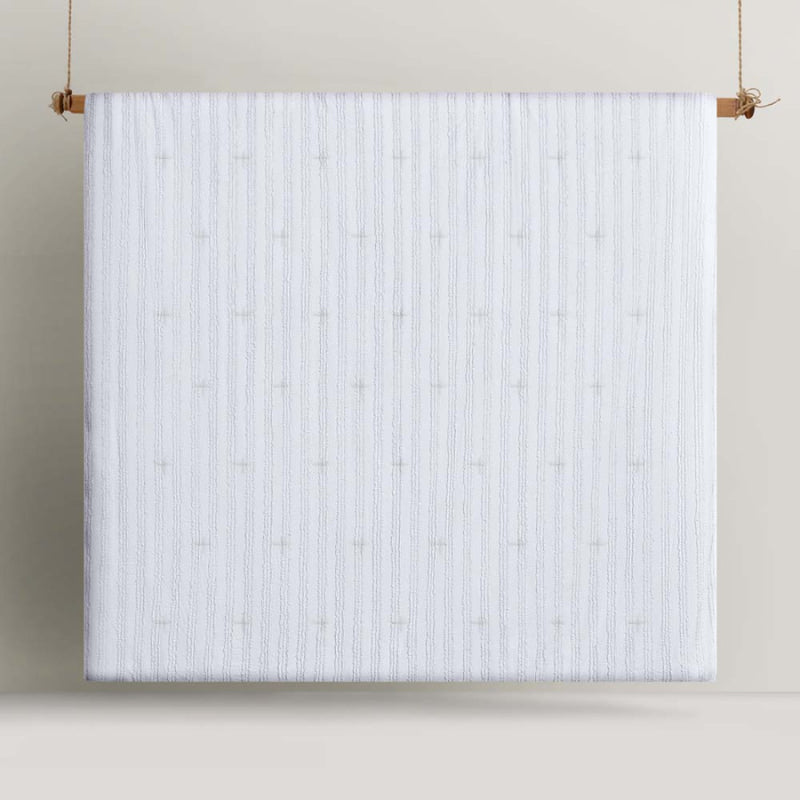 alt="Front details of a white comforter set featuring chenille stripes design"