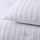 alt="Zoom in details of a white comforter set featuring chenille stripes design"