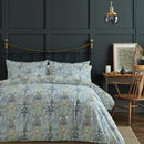 William Morris At Home Woodland Weeds Gold Quilt Cover Set styled on a bed, featuring intricate floral detailing in rich gold tones.
