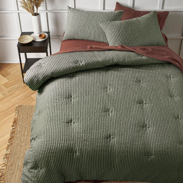Green waffle comforter set styled on bed with matching pillowcases.