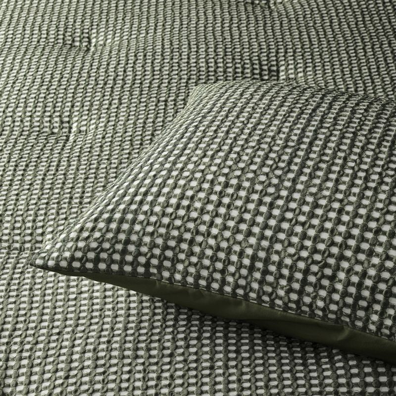 Green waffle comforter set styled on bed with matching pillowcases.