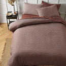 Tobacco waffle quilt cover set styled with matching pillowcases on a bed.