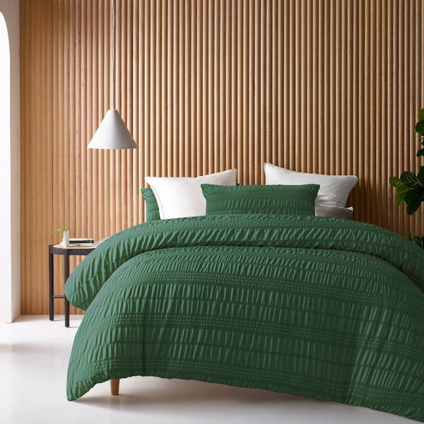 Accessorize Seersucker Hunter Green Quilt Cover Set styled on bed with white pillows.