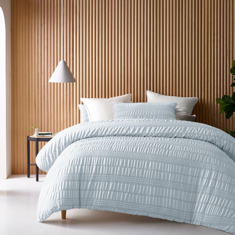 Accessorize Seersucker Ice Blue Quilt Cover Set styled with white pillows.