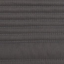 Lightweight dark grey coverlet set with soft texture and neutral cushions.