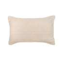 Soft neutral coverlet set paired with light cushions and timber bedside table.