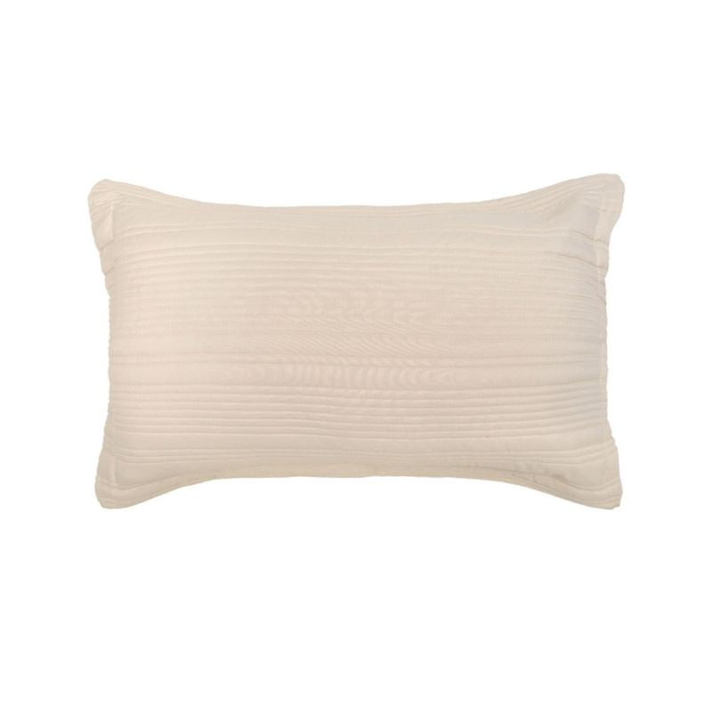 Soft neutral coverlet set paired with light cushions and timber bedside table.