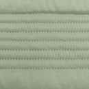 Lightweight sage coverlet set paired with neutral cushions on a timber bedside.