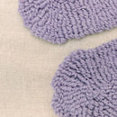 Soft cotton cushion with lilac floral accents for a modern, playful look.