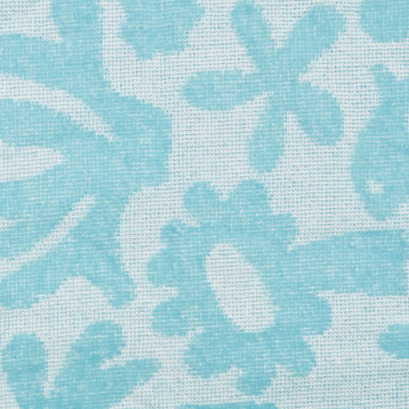 Close-up of soft cotton fabric with sky-blue pattern on the poncho.