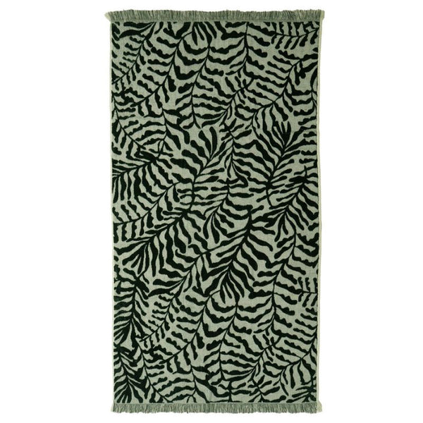 Luxurious green cotton beach towel with soft raised pattern and fringe edges.