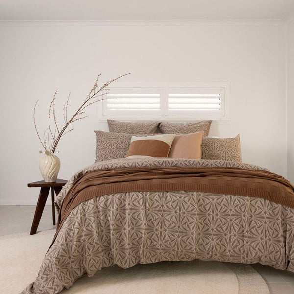 Bambury Huxley Brown Quilt Cover Set styled with warm earthy tones in a modern bedroom.