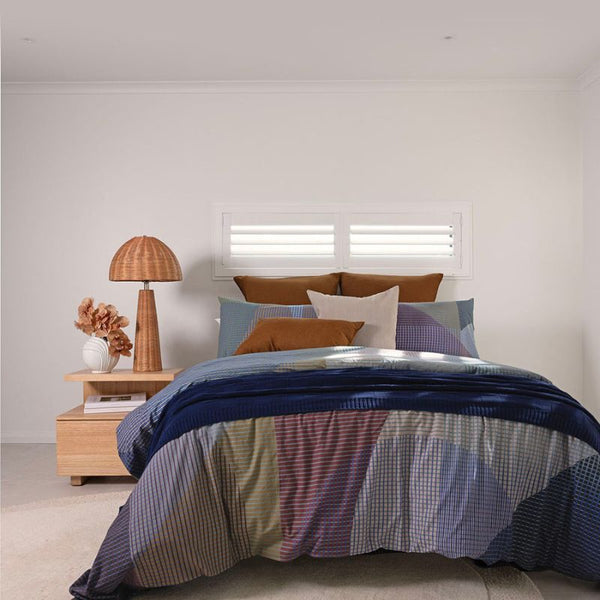 Bambury Iridia Quilt Cover Set styled in a modern bedroom with colourful patchwork design.