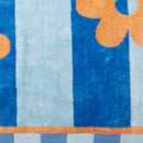 Bambury Jacquard Aster Beach Towel laid flat showing orange floral and blue stripe design.