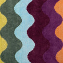Vibrant cotton beach towel featuring retro wavy stripes from Bambury.