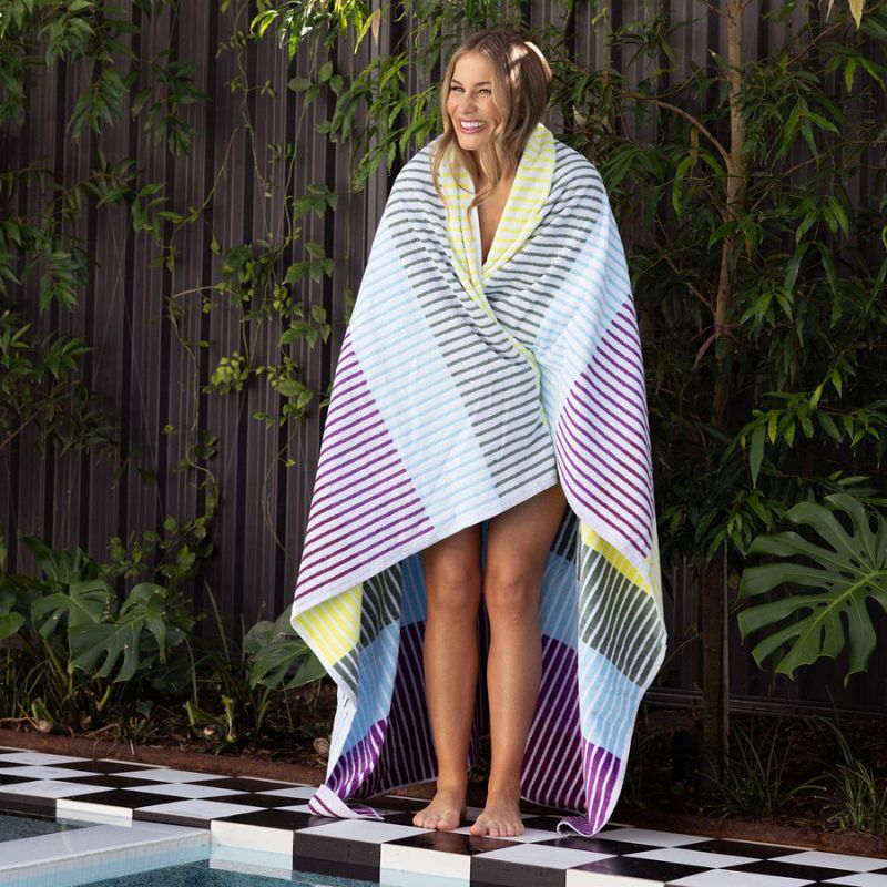 The Bambury Jacquard Strata Beach Blanket combines comfort and colour in the best way possible. Made from soft, high-quality cotton, it’s perfect for warm days spent outdoors. Its lively mix of stripes in yellow, purple, green, and blue adds personality to your summer adventures, whether at the beach, by the pool, or in the park. Stylish, practical, and made to last — this is your go-to blanket for sunshine and good times.