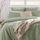 Close-up of sage green linen European pillowcase showing relaxed, natural texture.