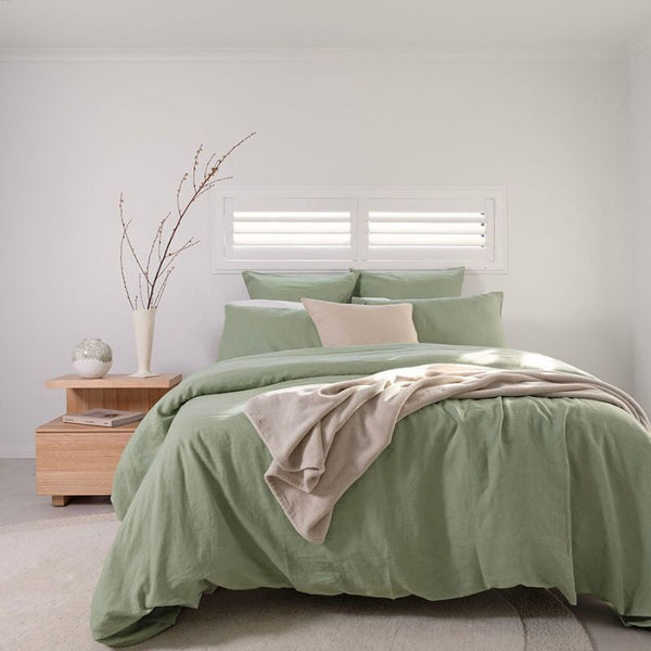 Close-up of sage green linen quilt cover showing relaxed, soft texture.