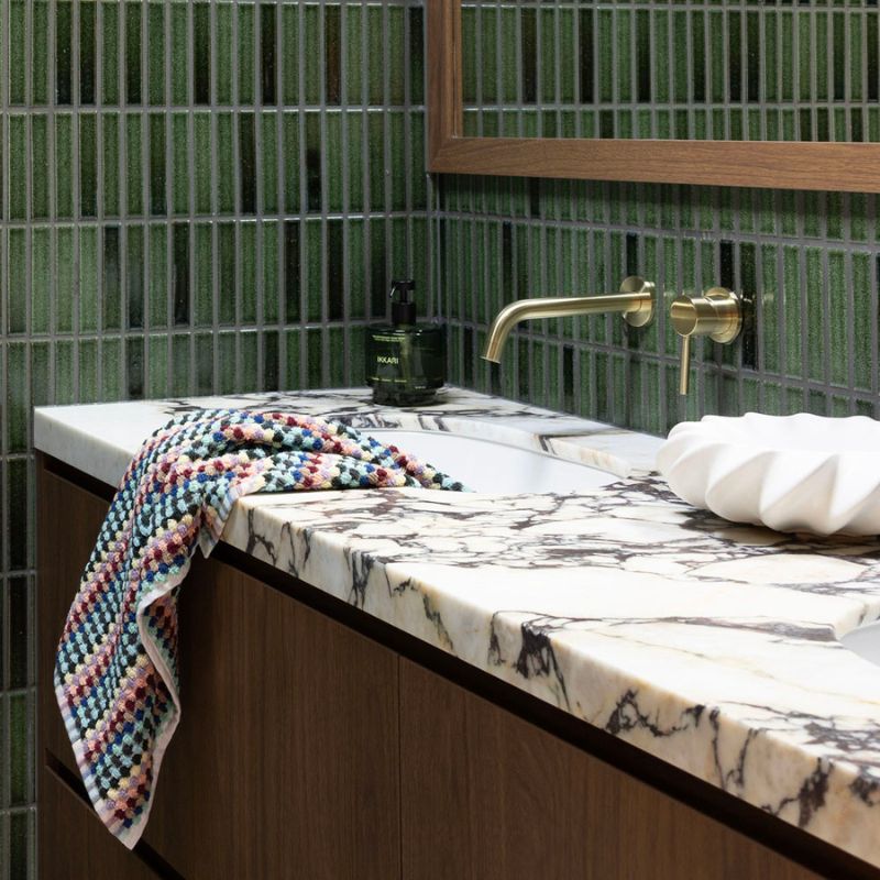 Retro-inspired Bambury Miami Pom Pom Hand Towel styled in a modern bathroom.