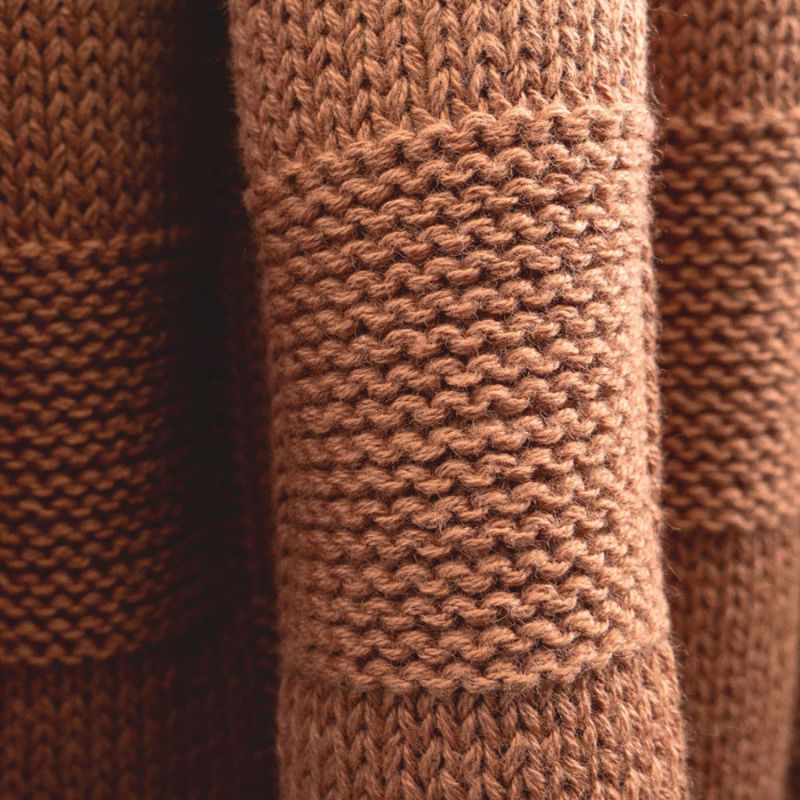 Warm-toned knitted throw blanket in biscuit colour by Bambury, styled for everyday comfort.