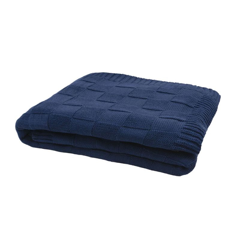 Close-up of the knitted texture and square pattern on the navy throw.