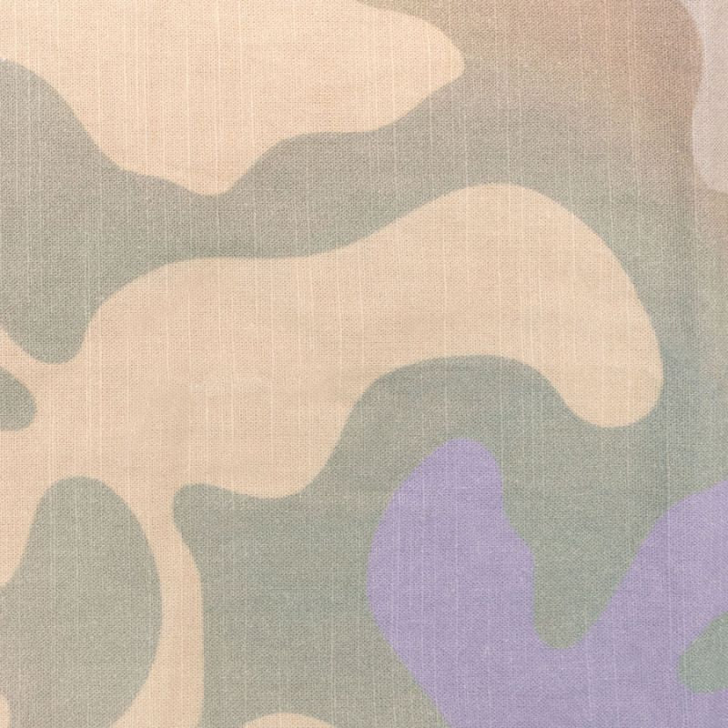 Close-up of cotton quilt cover showing subtle floral pattern in beige and sage tones.