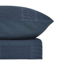 Blue haze waffle quilt cover set with matching pillowcases and beige headboard